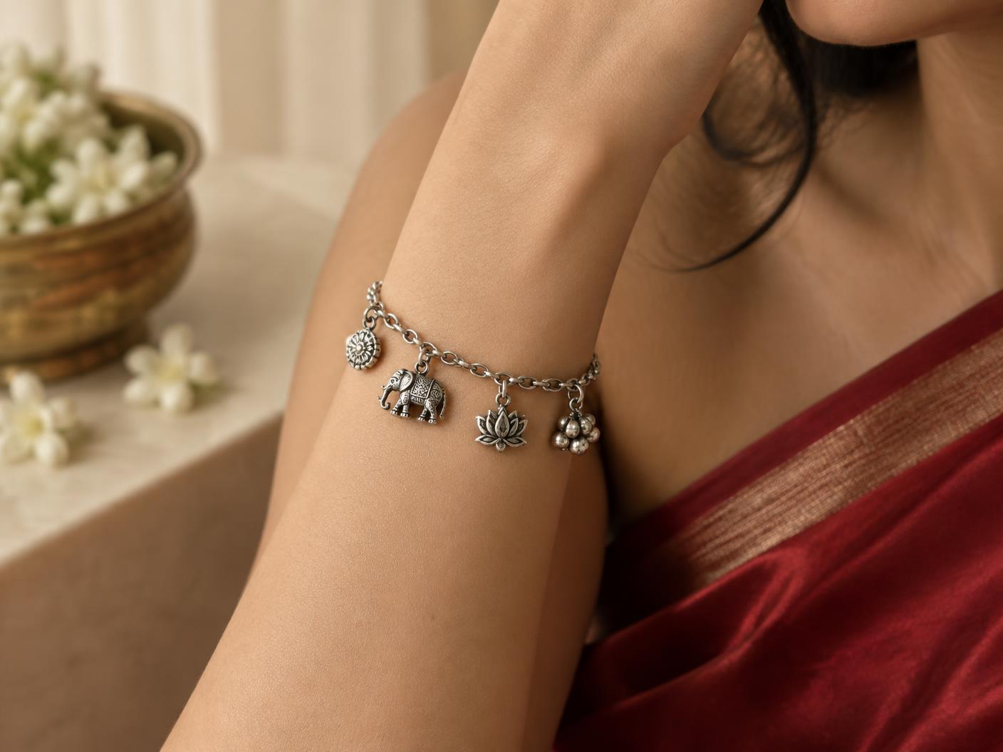 Ishq silver charm bracelet worn on the wrist